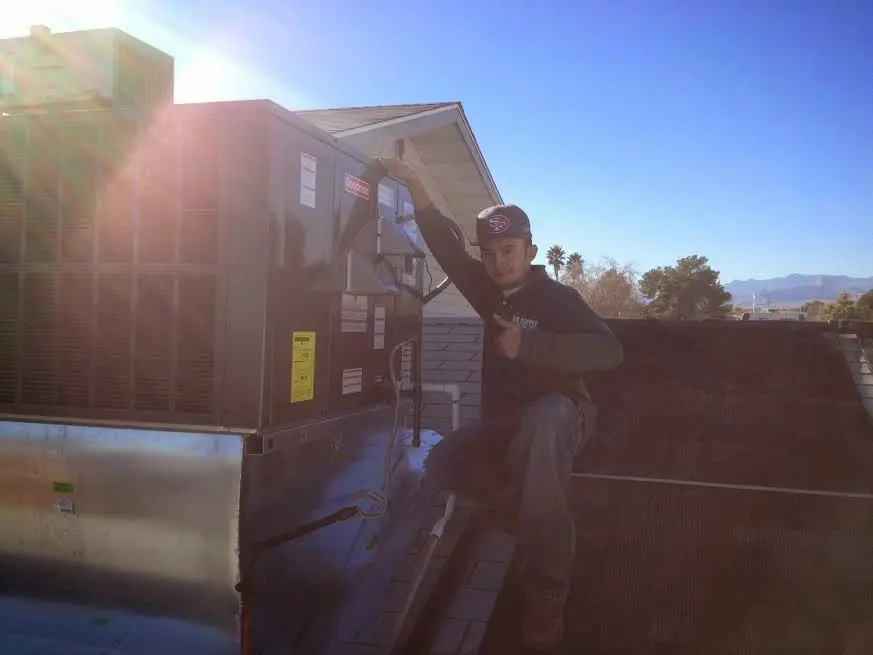 HVAC technician performing Boiler Repair on a rooftop unit in Fairhaven